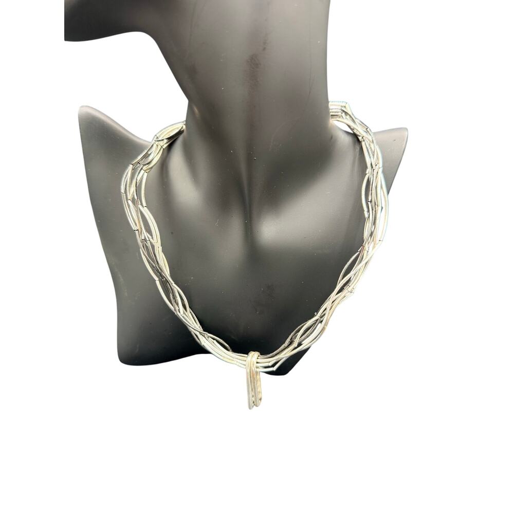 Silver-tone multi-strand tubular chain necklace. Layered w textured accent 17”
